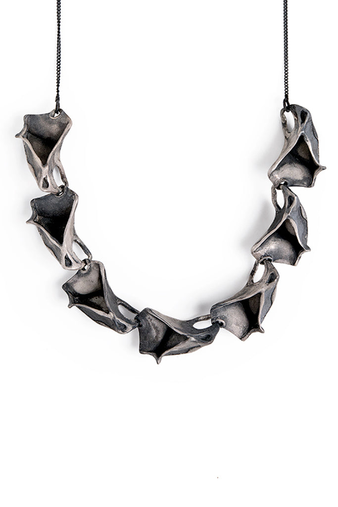 unique contemporary handmade statement necklace made of oxidized sterling silver inspired by nature ocean  made by lacuna jewelry