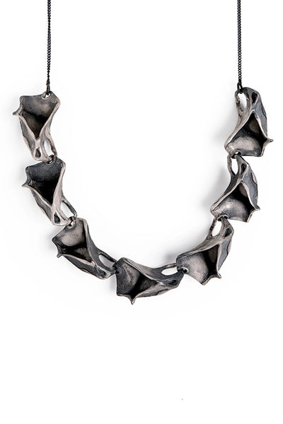 unique contemporary handmade statement necklace made of oxidized sterling silver inspired by nature ocean  made by lacuna jewelry
